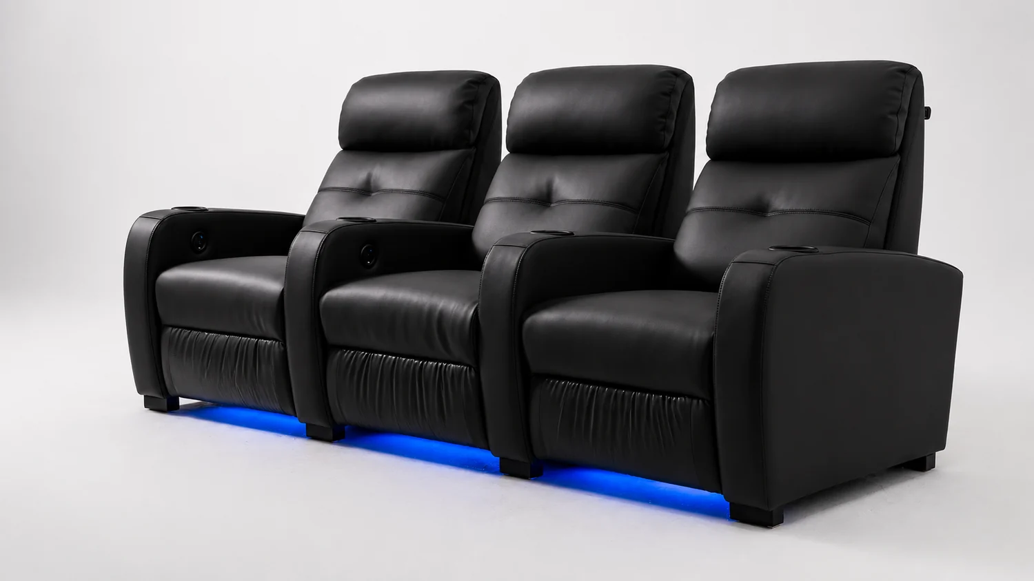 Row of LumeO Sava home cinema seats in matte black leather, blue LED base lighting